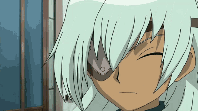 a close up of a person 's face with white hair and a blue shirt