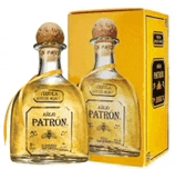 two bottles of patron tequila are next to a yellow box .