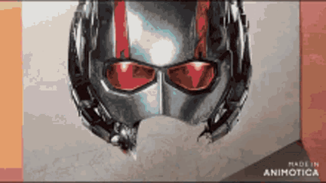 a picture of an antman helmet with red eyes