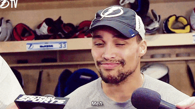 a man wearing a lightning hat is being interviewed by a sports broadcaster
