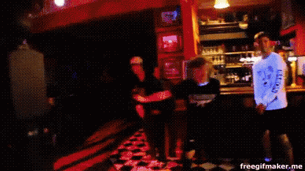 a blurry picture of people dancing in a bar with the words freegifmaker.me at the top