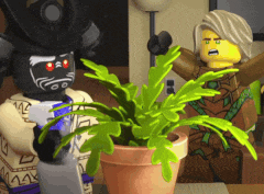 a couple of lego characters standing next to a potted plant