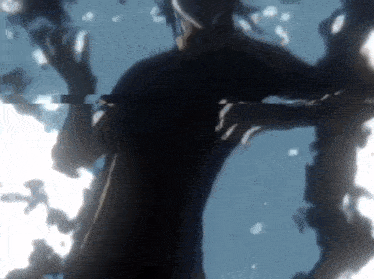 a silhouette of a person in a dark room with a blurry background