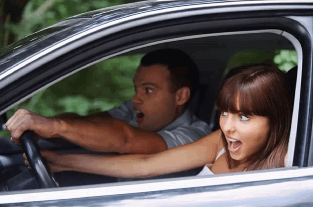 a man and a woman are sitting in a car