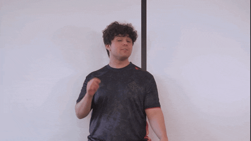 a man wearing a black shirt with a logo that says ' nsf ' on it