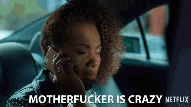 a woman in a car talking on a cell phone with the caption motherfucker is crazy