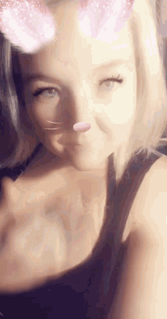 a woman wearing a cat filter on her face