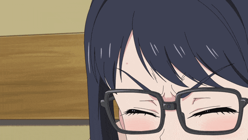 a close up of a person wearing glasses with their eyes closed and a red spot on their forehead