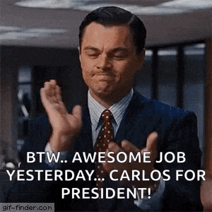 a man in a suit and tie is clapping his hands and saying btw awesome job yesterday carlos for president .