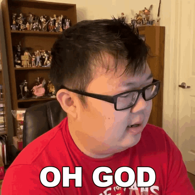 a man wearing glasses and a red shirt that says " oh god "