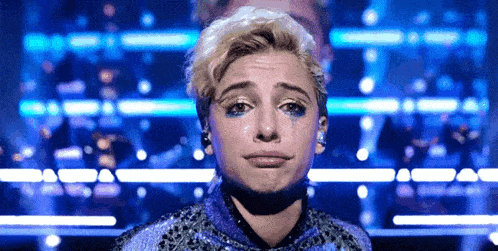 a close up of a woman with tears on her face