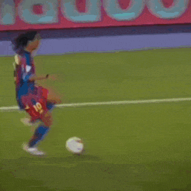 a soccer player wearing a number 2 jersey is kicking the ball