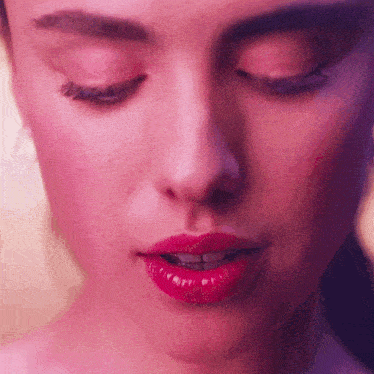 a close up of a woman 's face with pink lips