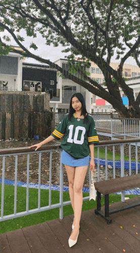 a girl wearing a green jersey with the number 10