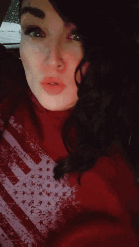 a woman wearing a red shirt with an american flag printed on it