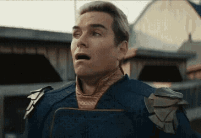 a man with a surprised look on his face is wearing a blue uniform