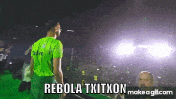 a man in a green shirt stands in front of a crowd with the words rebola txitxon on the bottom