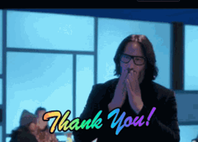 a man wearing glasses is covering his mouth with his hands and the words thank you are above him