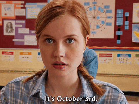a woman says it 's october 3rd in a classroom
