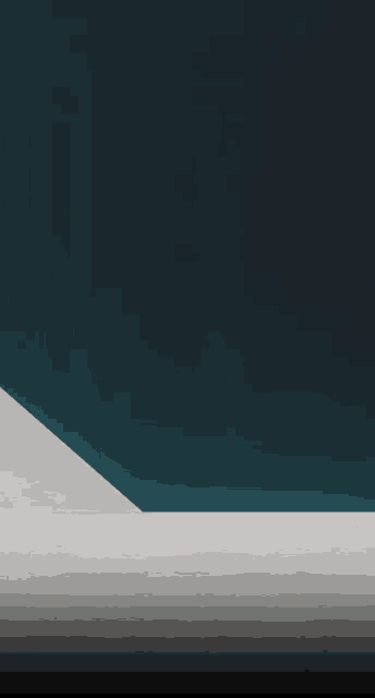a corner of a room with a dark blue wall