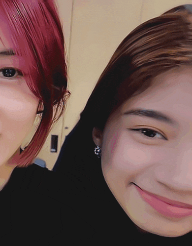 a woman with red hair is standing next to another woman with brown hair