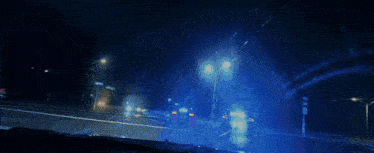 a blurred image of a police car driving down a street