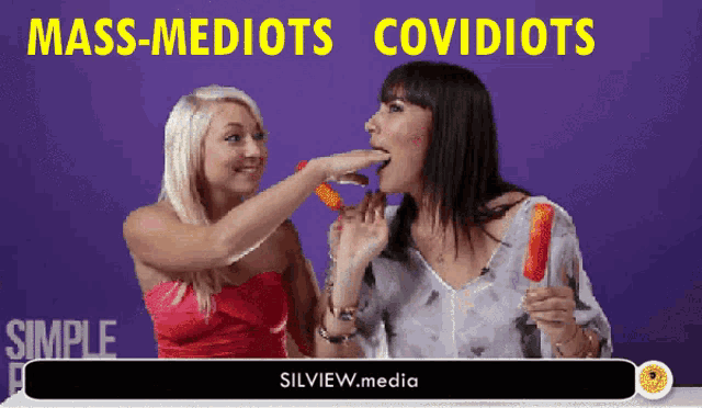 two women eating popsicles with the words mass-mediots covidiots on the bottom