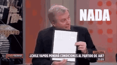 a man in a suit is holding a piece of paper and says nada