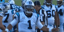 a group of football players are standing in a huddle with one wearing a number 1 jersey