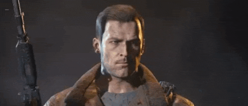 a man in a leather jacket is holding a gun in his right hand .