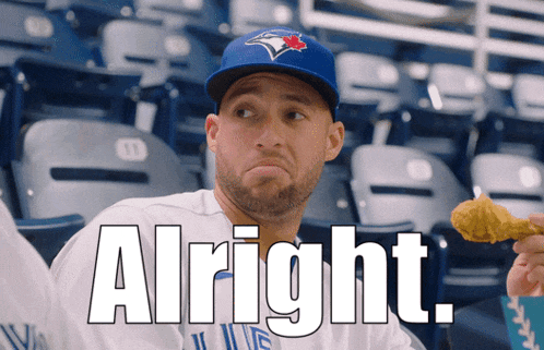 a man wearing a blue jays hat is holding a fried chicken wing and the words alright are above him