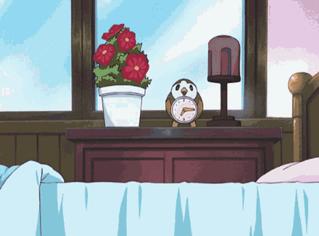 an alarm clock sits on a nightstand next to a plant