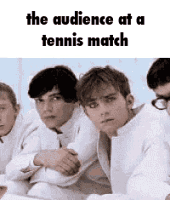 a group of young men are sitting next to each other with the caption the audience at a tennis match .