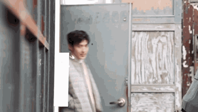 a man is standing in front of a door that says ' abercrombie ' on it
