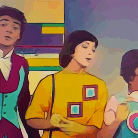 a woman wearing a yellow shirt with squares on the front