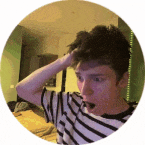 a young man in a striped shirt is holding his head in a circle .