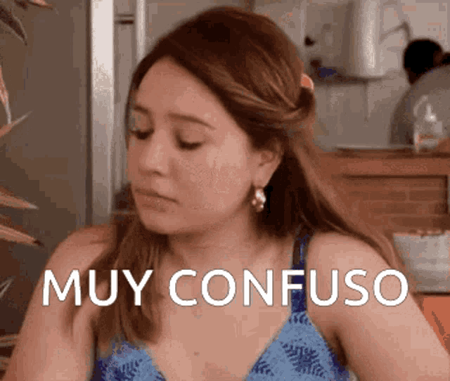 a woman in a blue tank top has the word muy confuso on her face