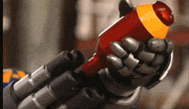 a robotic hand is holding a red and yellow item