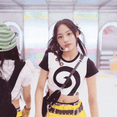 a girl wearing a black and white crop top with a s on it
