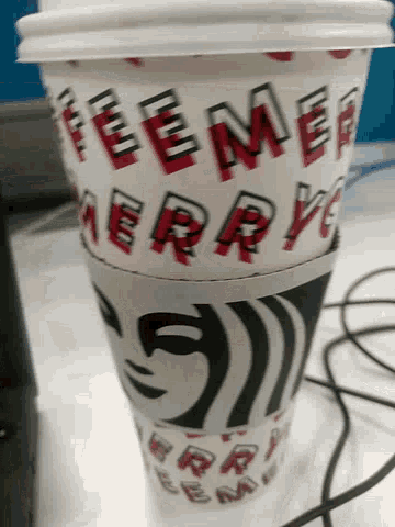 a coffee cup that says ' berry ' on it is sitting on a table