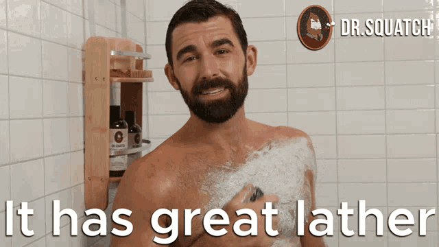 a man taking a shower with the words " it has great lather " below him