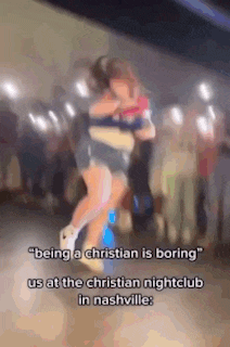 a couple of girls are hugging each other in front of a crowd .