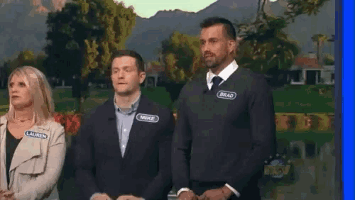 a group of people are standing next to each other and one of them has a name tag that says brad