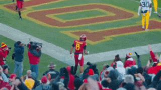 a football player with the number 8 on his jersey is standing on the field