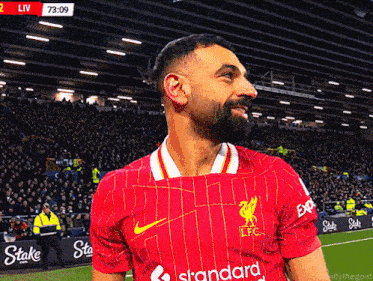 a man wearing a red jersey that says standard on the front