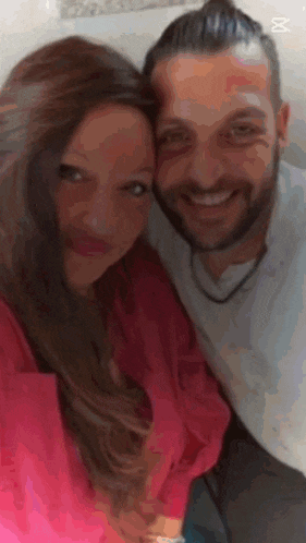 a man and a woman are posing for a picture together