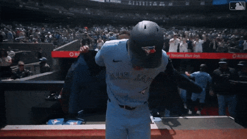 two toronto baseball players are hugging each other