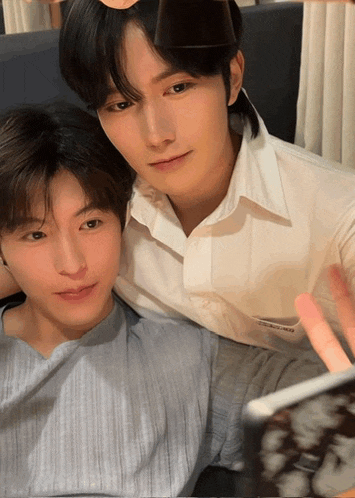 two young men are posing for a picture and one of them is wearing a shirt that says ' dolce & gabbana '