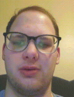 a man wearing glasses is looking at the camera with a yellow background