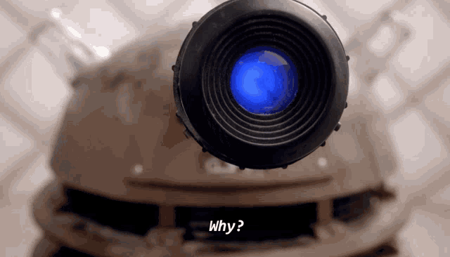 a close up of a camera lens with the word why written below it